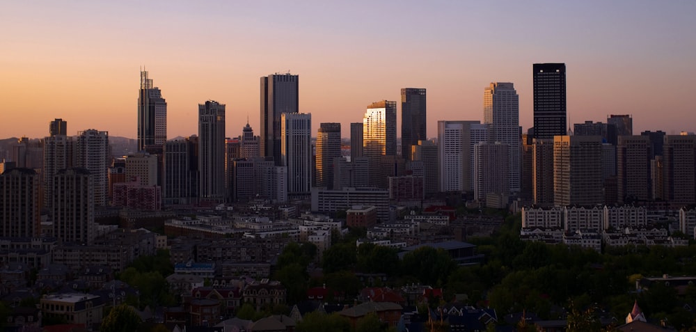 a view of a city skyline at sunset