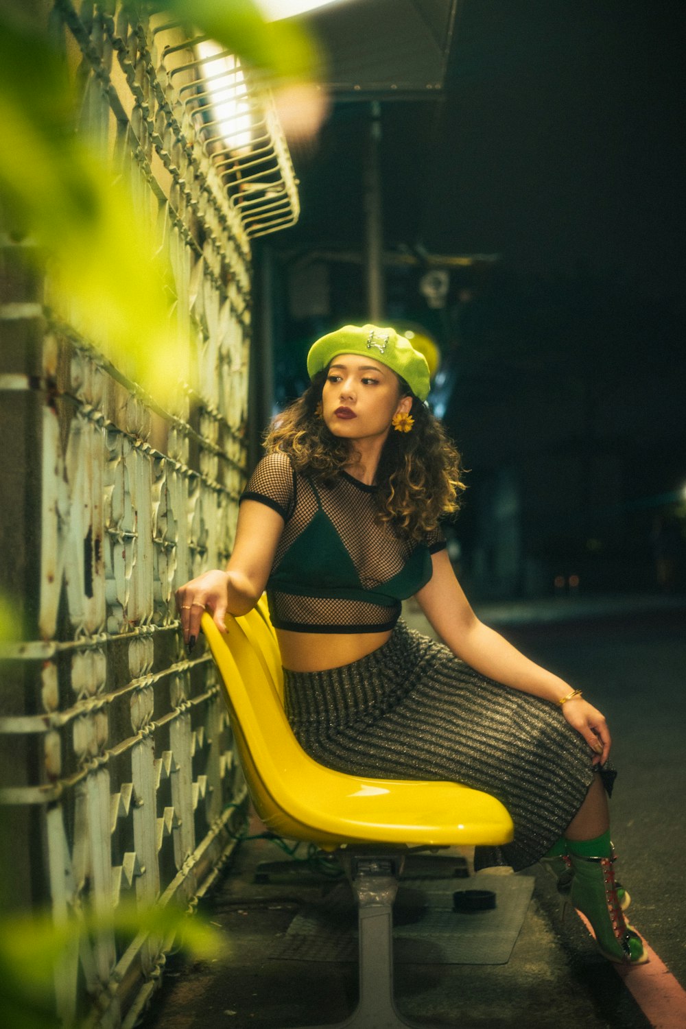 a woman sitting on top of a yellow chair