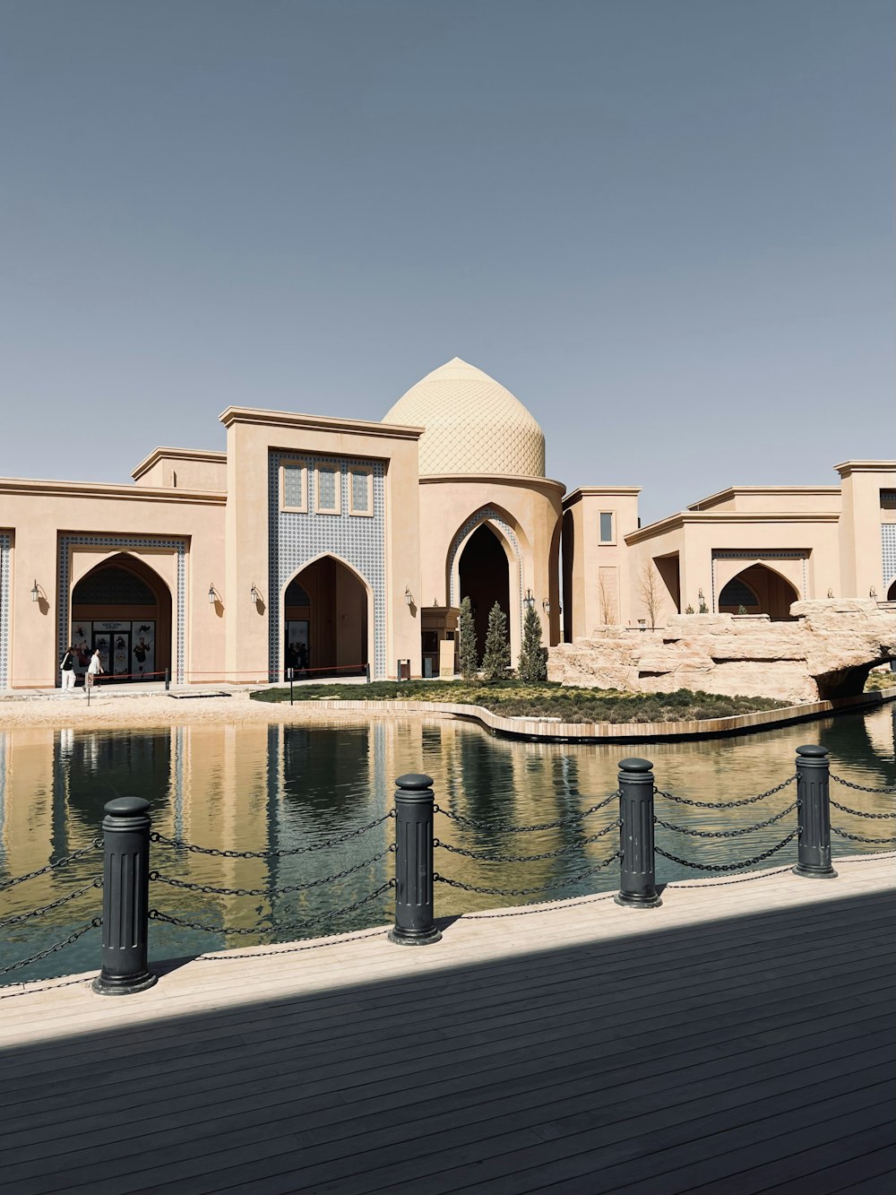 a large building with a pool in front of it