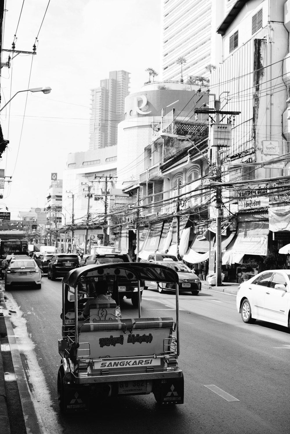 a black and white photo of a busy city street