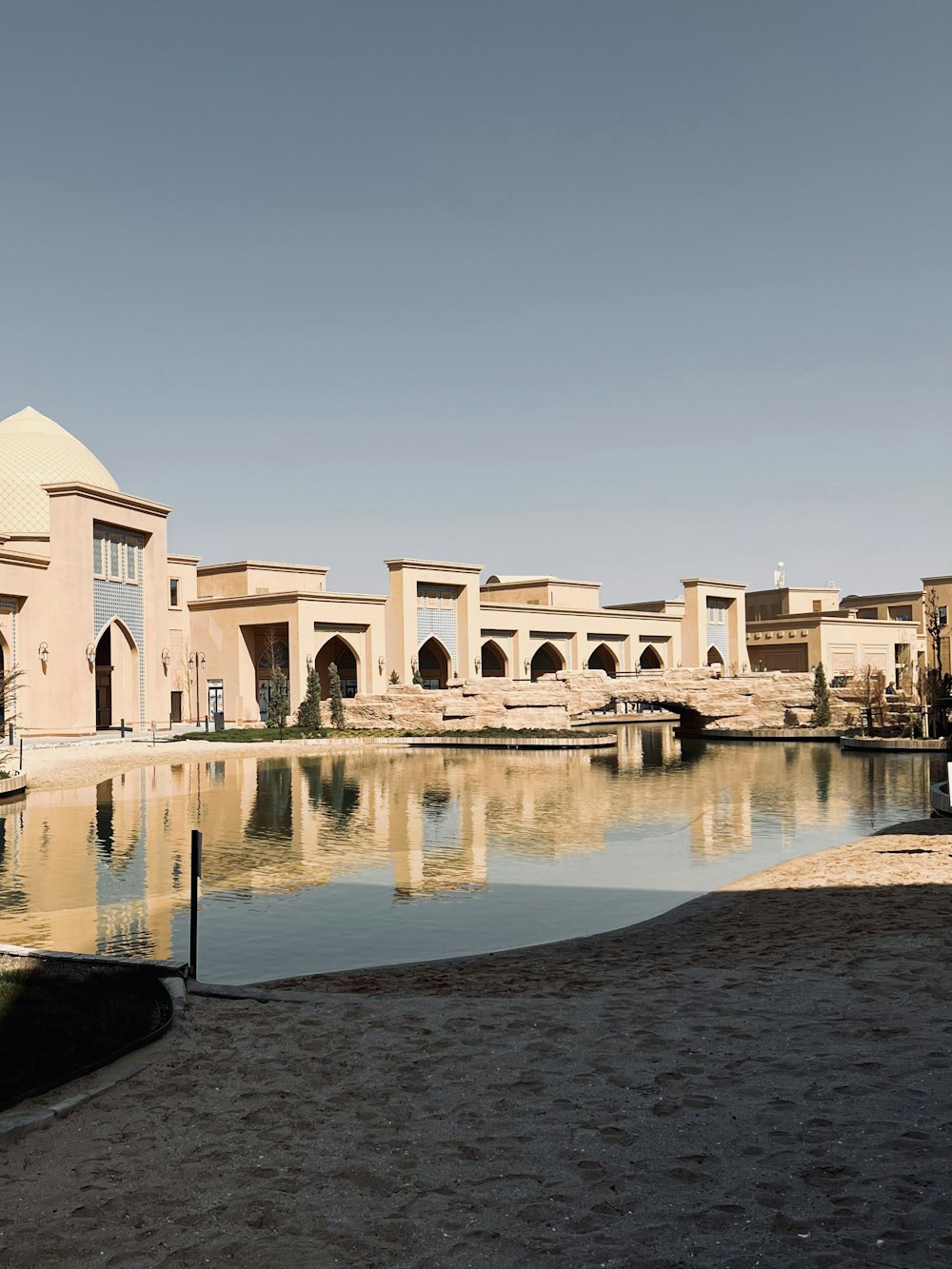 a large building sitting next to a body of water