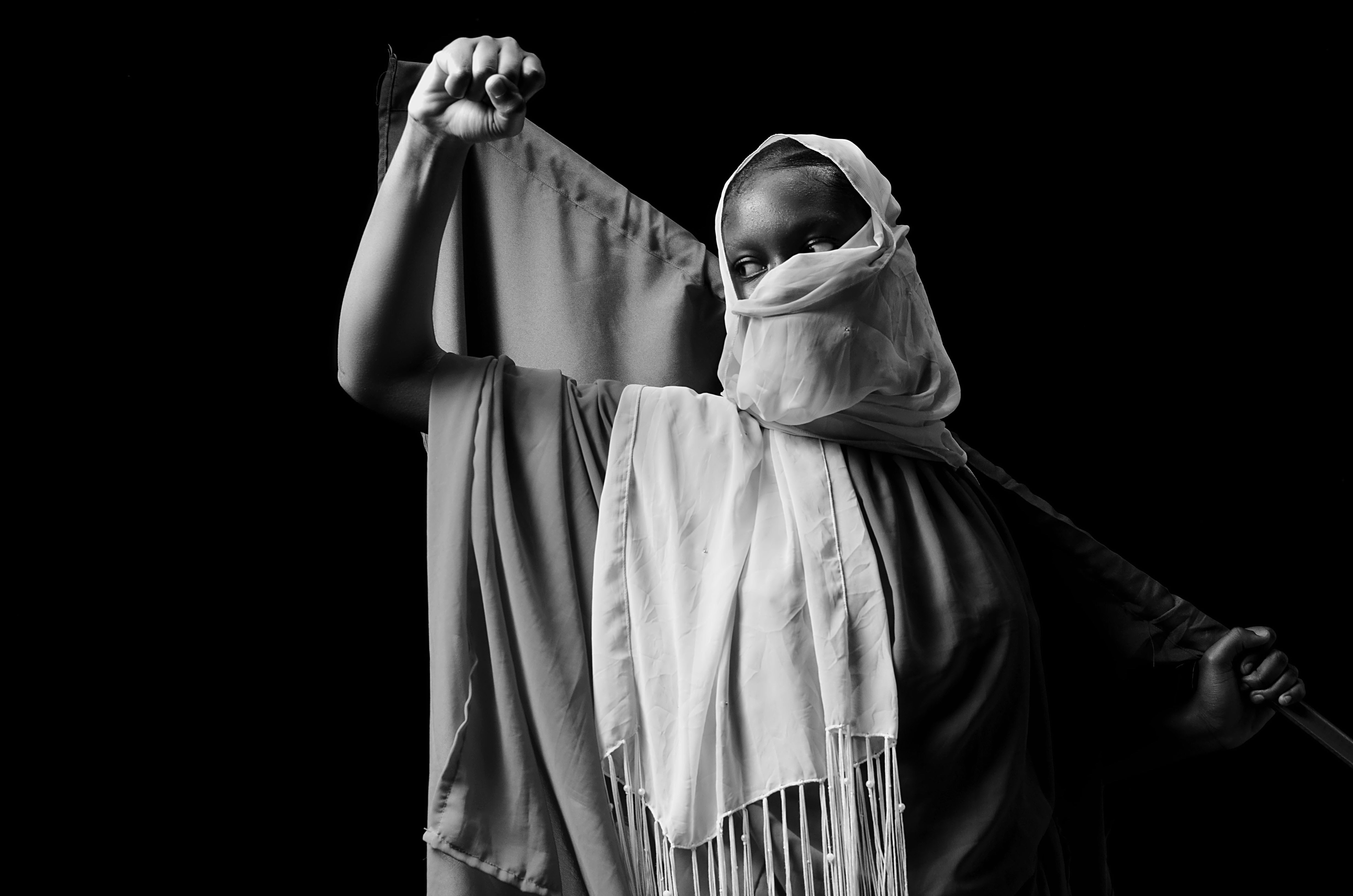 foto hitam putih seorang wanita memegang tongkat bisbol