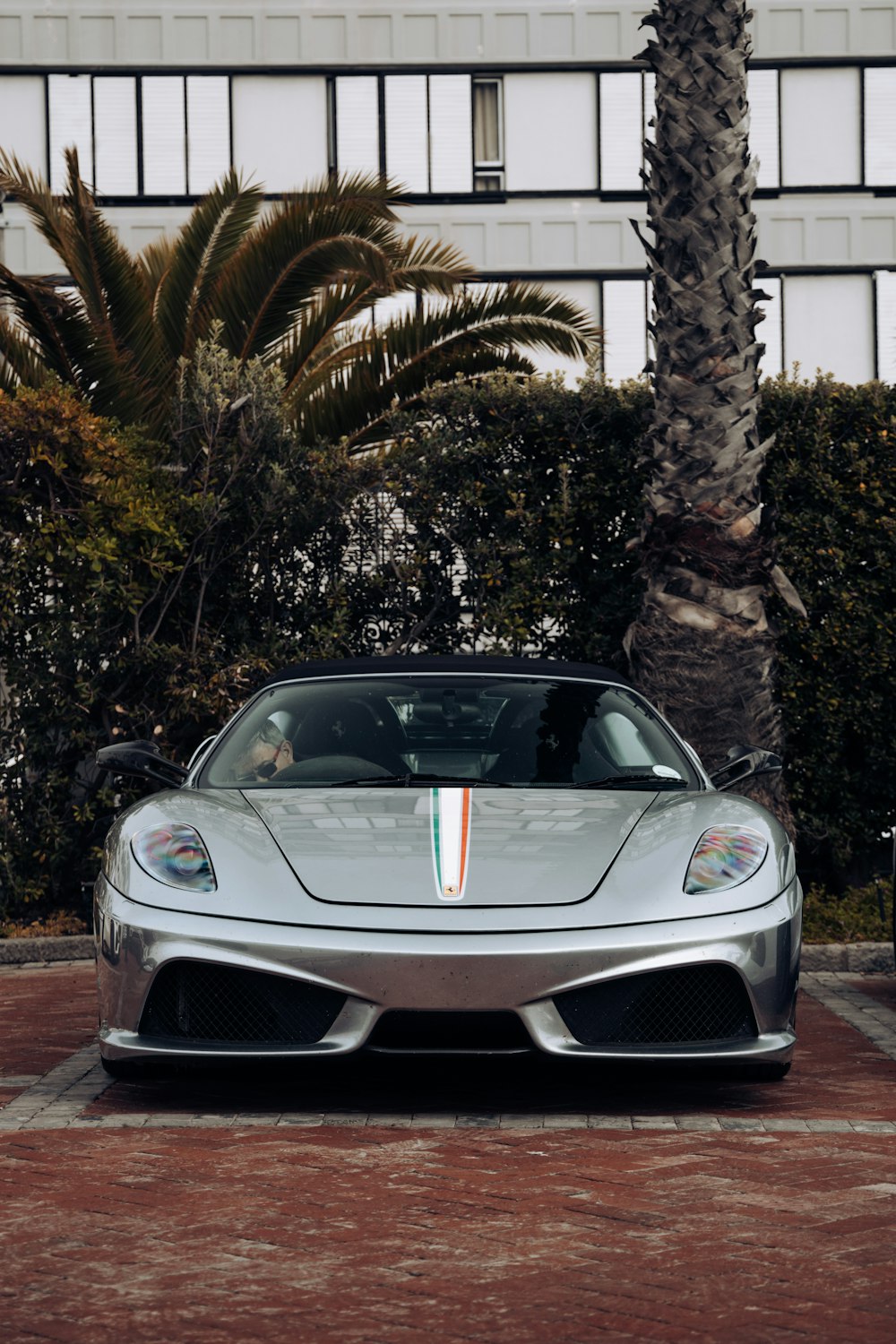 a silver sports car parked in a parking lot