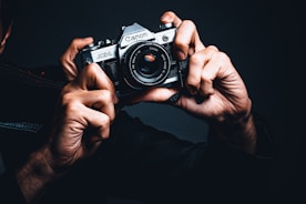 a man holding a camera up to his face