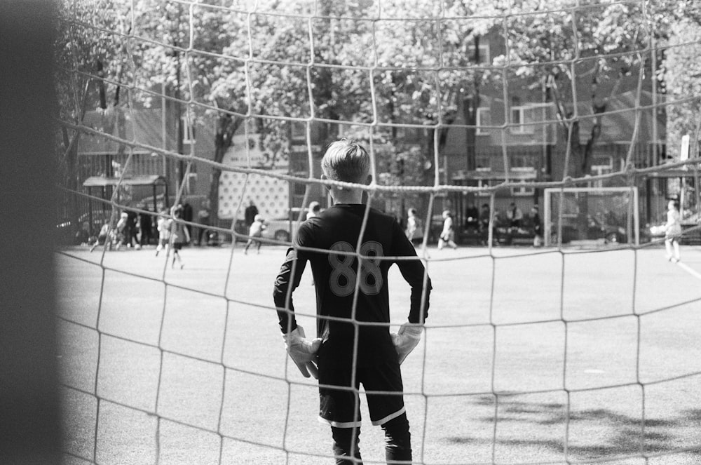 a man standing in front of a soccer net