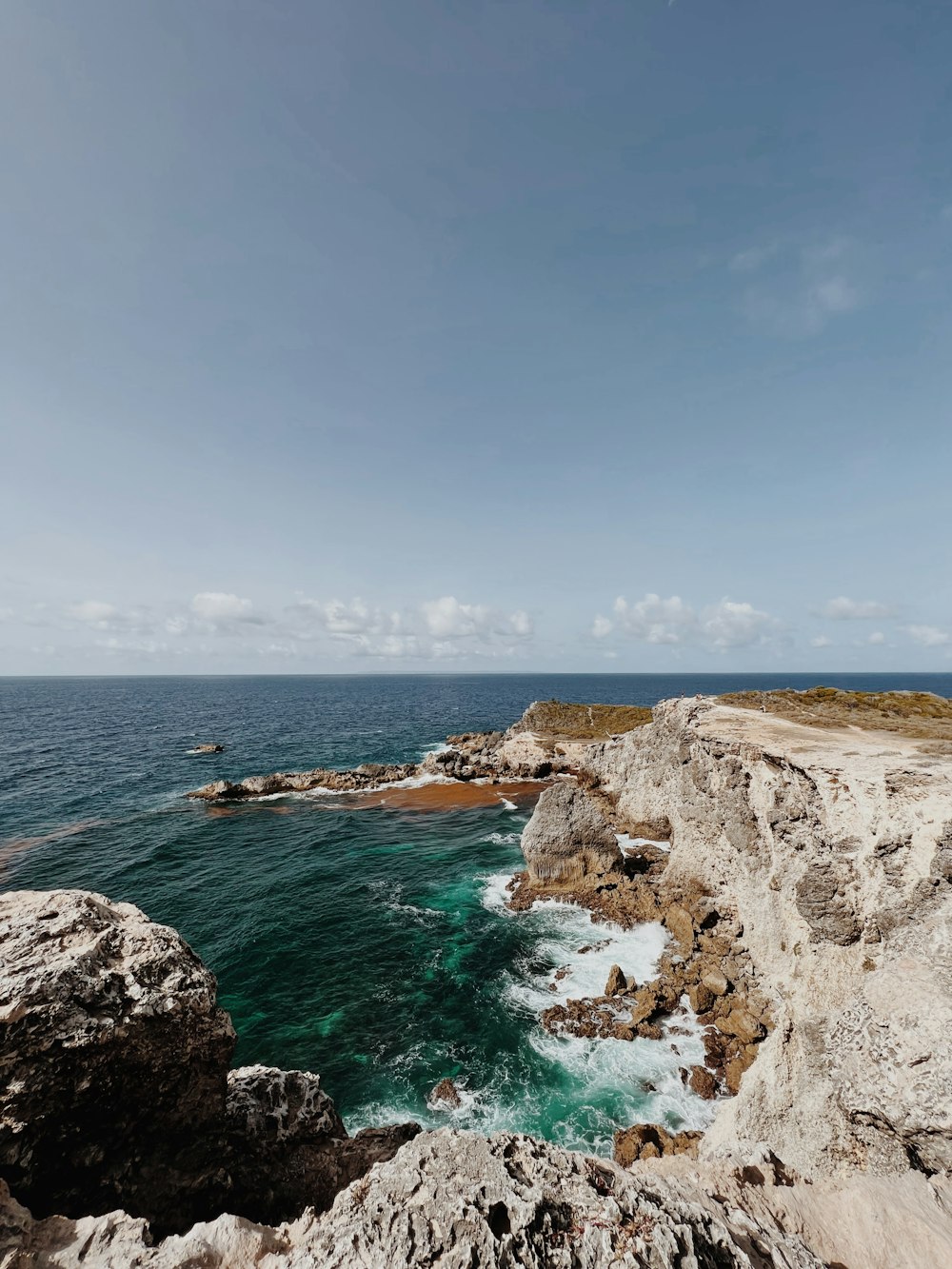 a view of the ocean from a rocky cliff