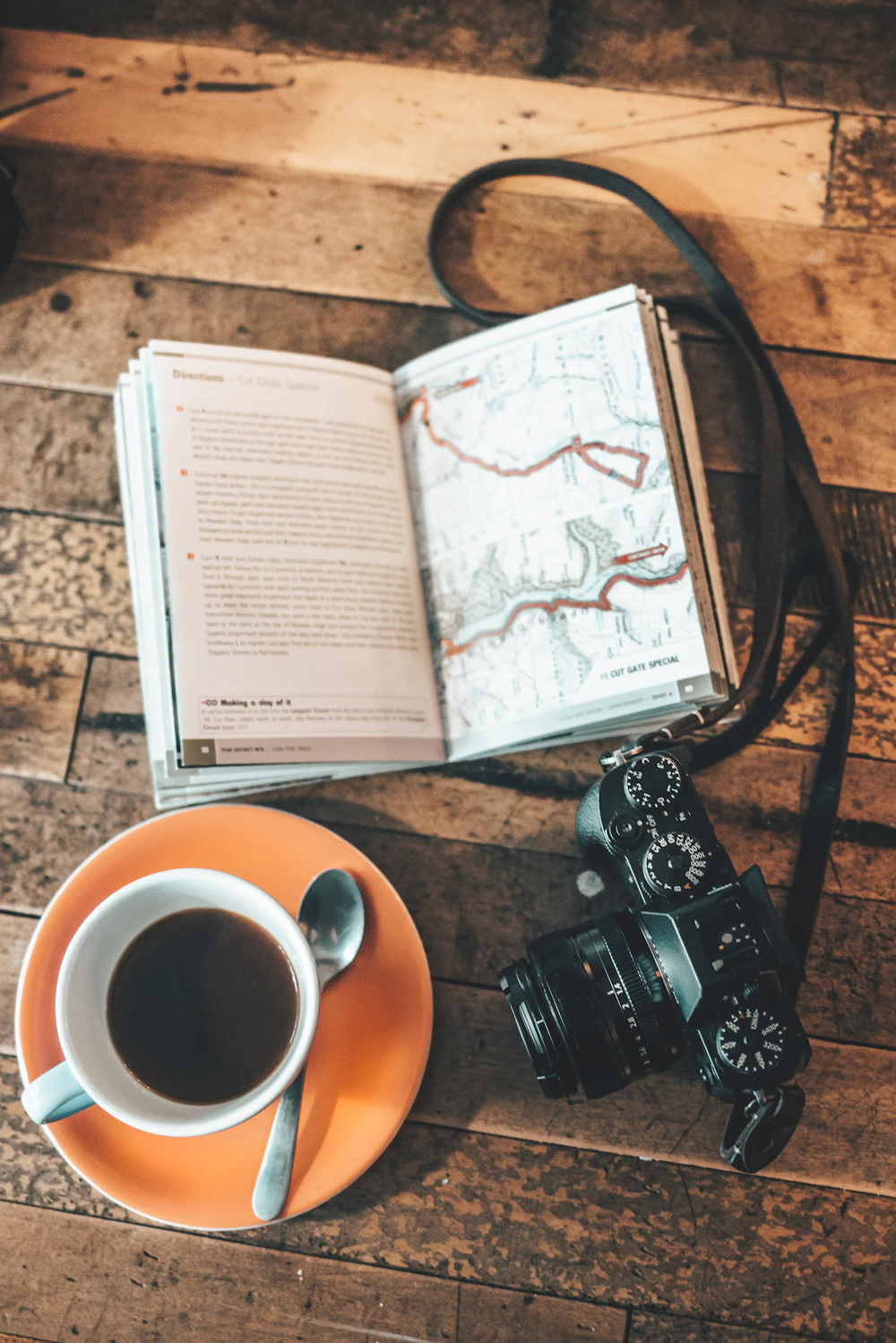 Camera, book and coffee on a table