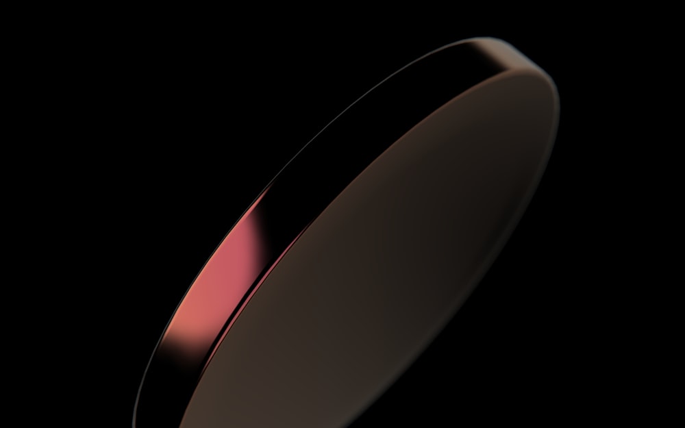 a close up of a metal object on a black background