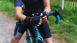 A person wearing durable gloves while biking through a crisp autumn park.
