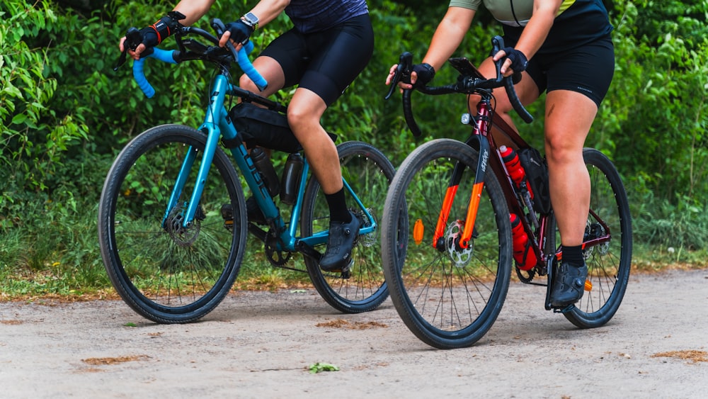 a couple of people riding bikes down a road