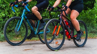 a couple of people riding bikes down a road