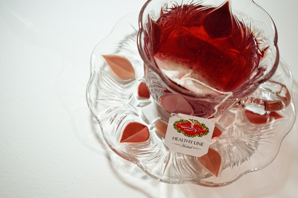 a glass bowl filled with candy canes on top of a table