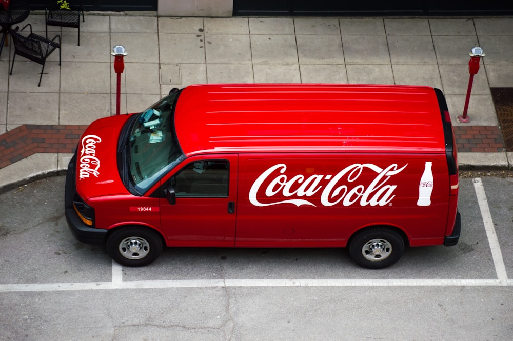a coca cola van parked in a parking lot