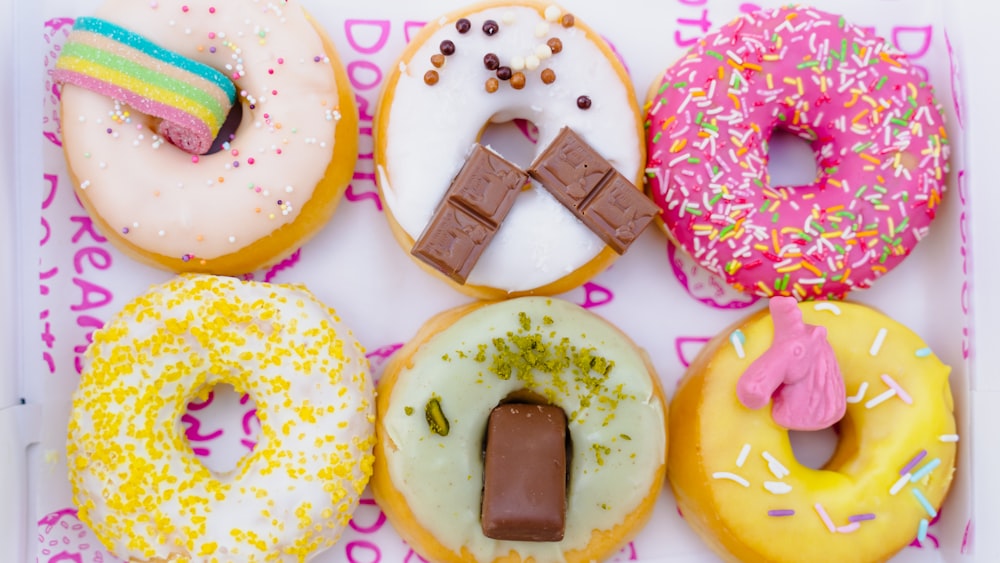 a box filled with lots of different flavored donuts