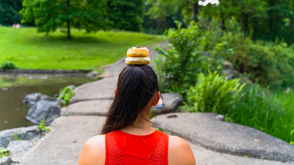 a woman with a donut on top of her head