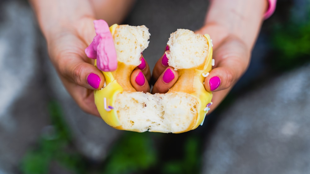 a person holding a piece of food in their hands