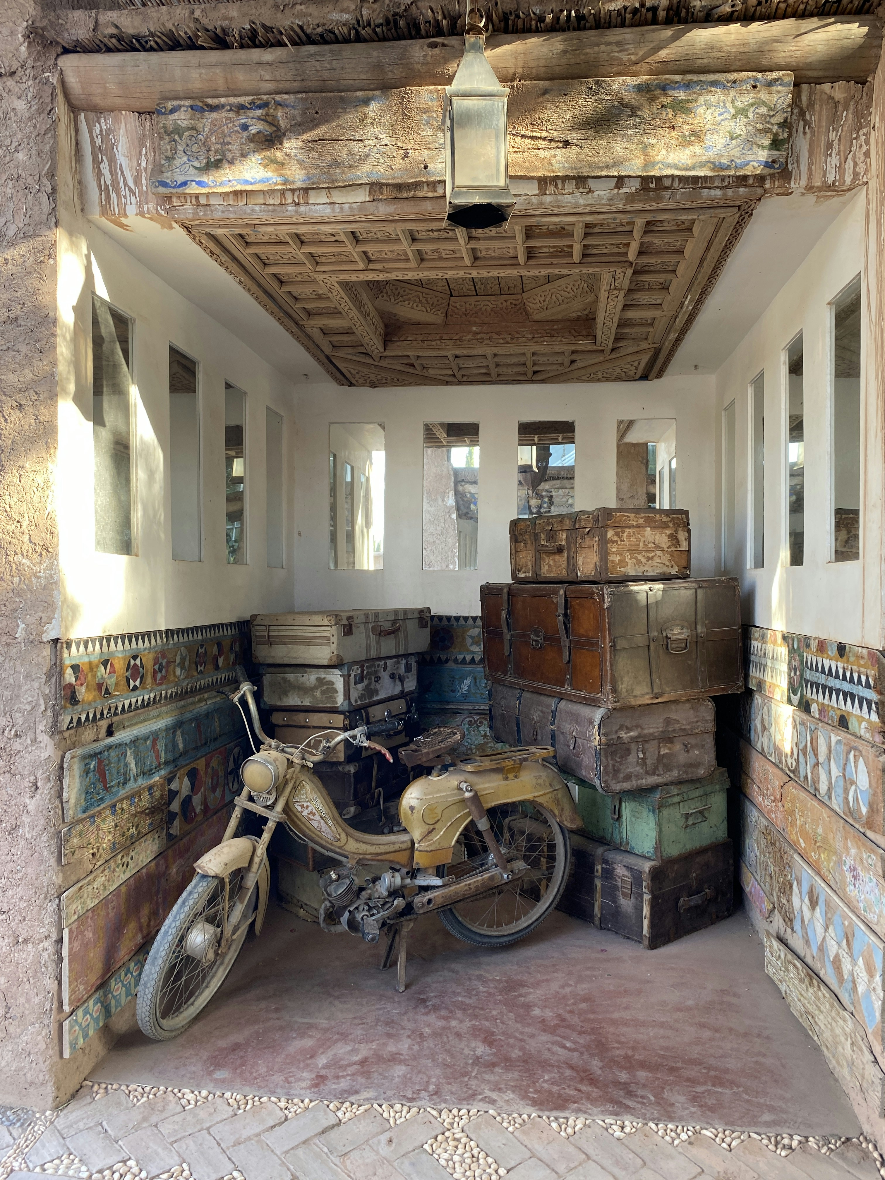 a motorcycle is parked in a room full of suitcases