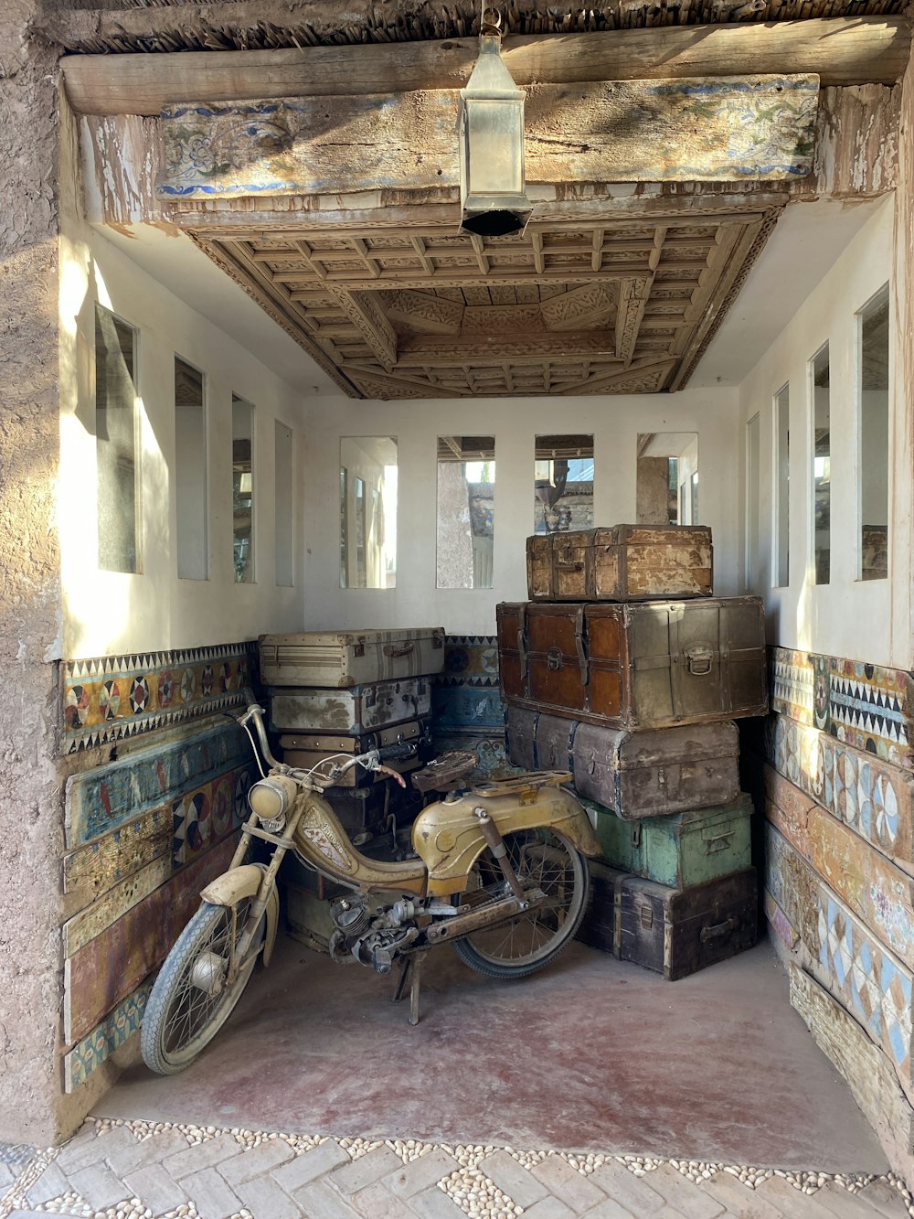 a motorcycle is parked in a room full of suitcases