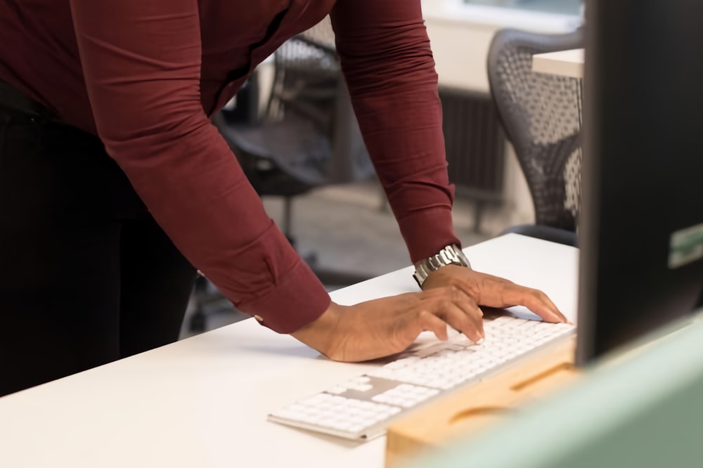 a person is typing on a computer keyboard