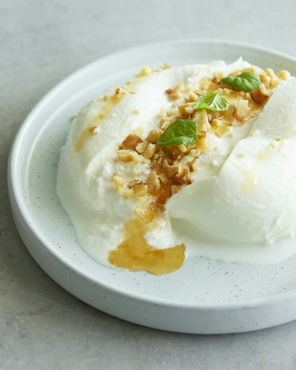 a white plate topped with a scoop of ice cream