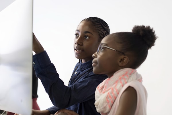 Two students collaborating at a computer