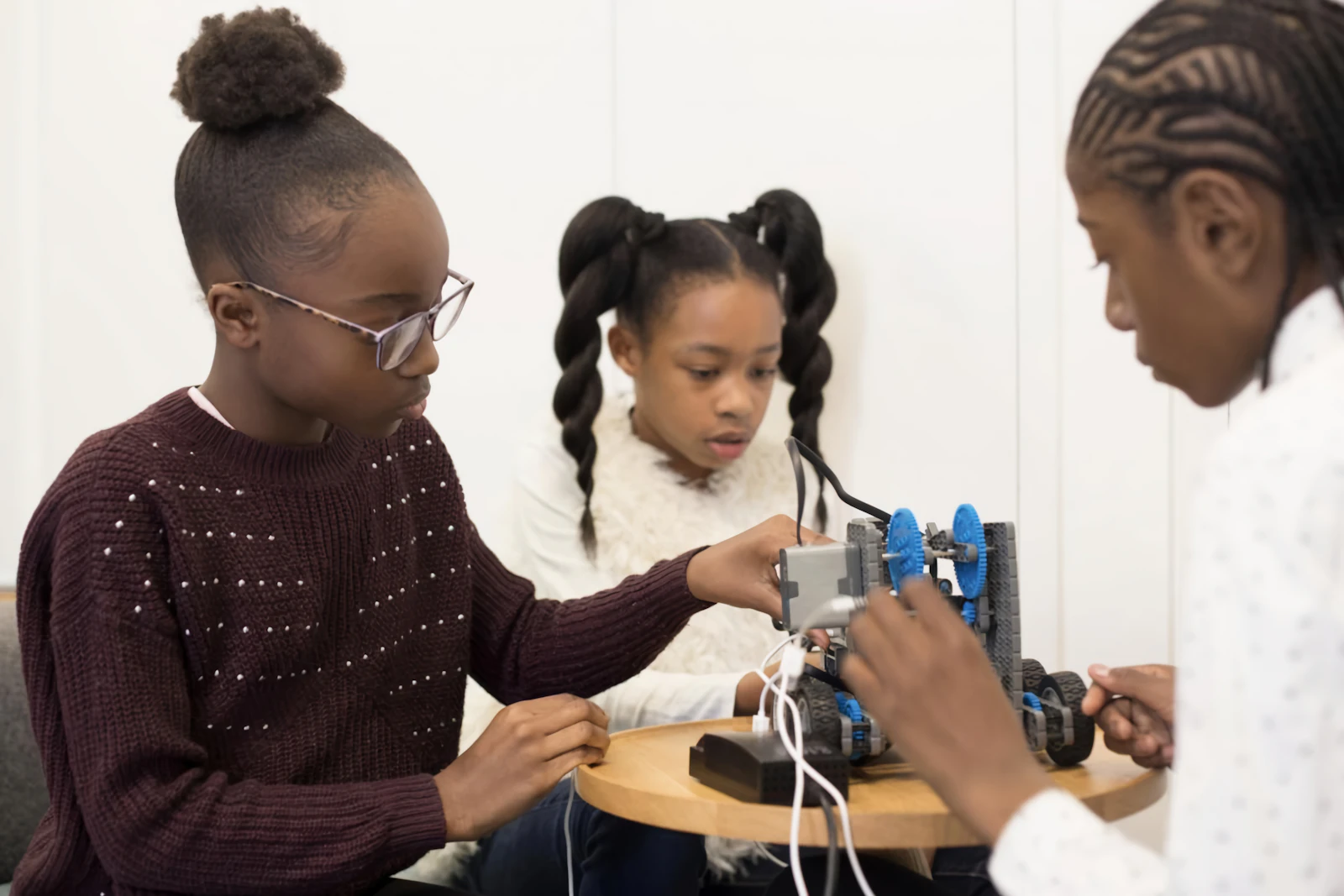 Two students building a robotics project together
