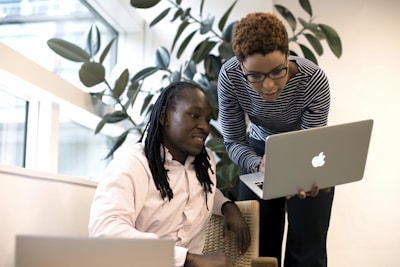 two women looking at a laptop computer screen