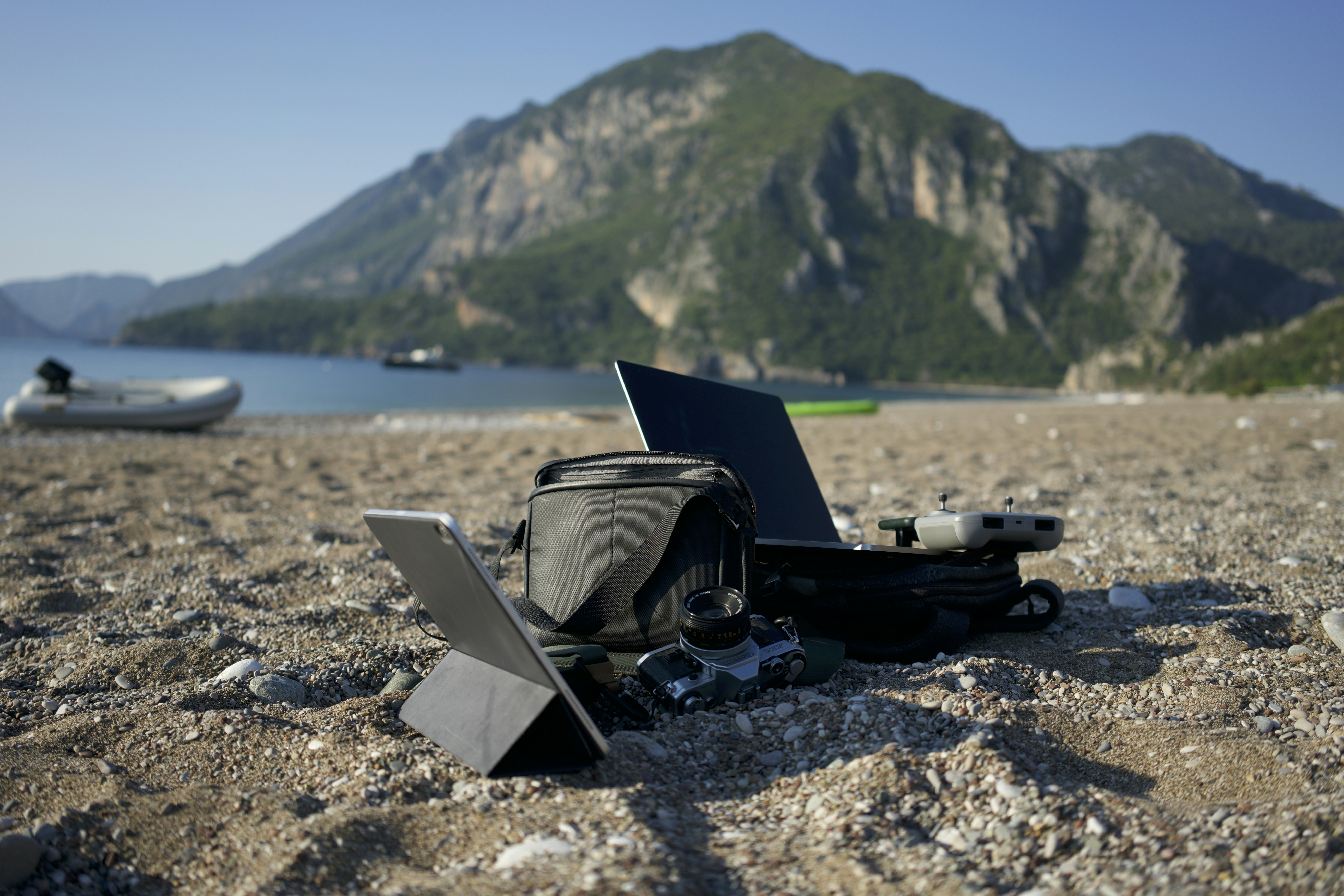 a laptop computer sitting on top of a sandy beach