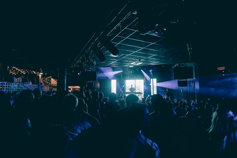 a crowd of people standing around a stage