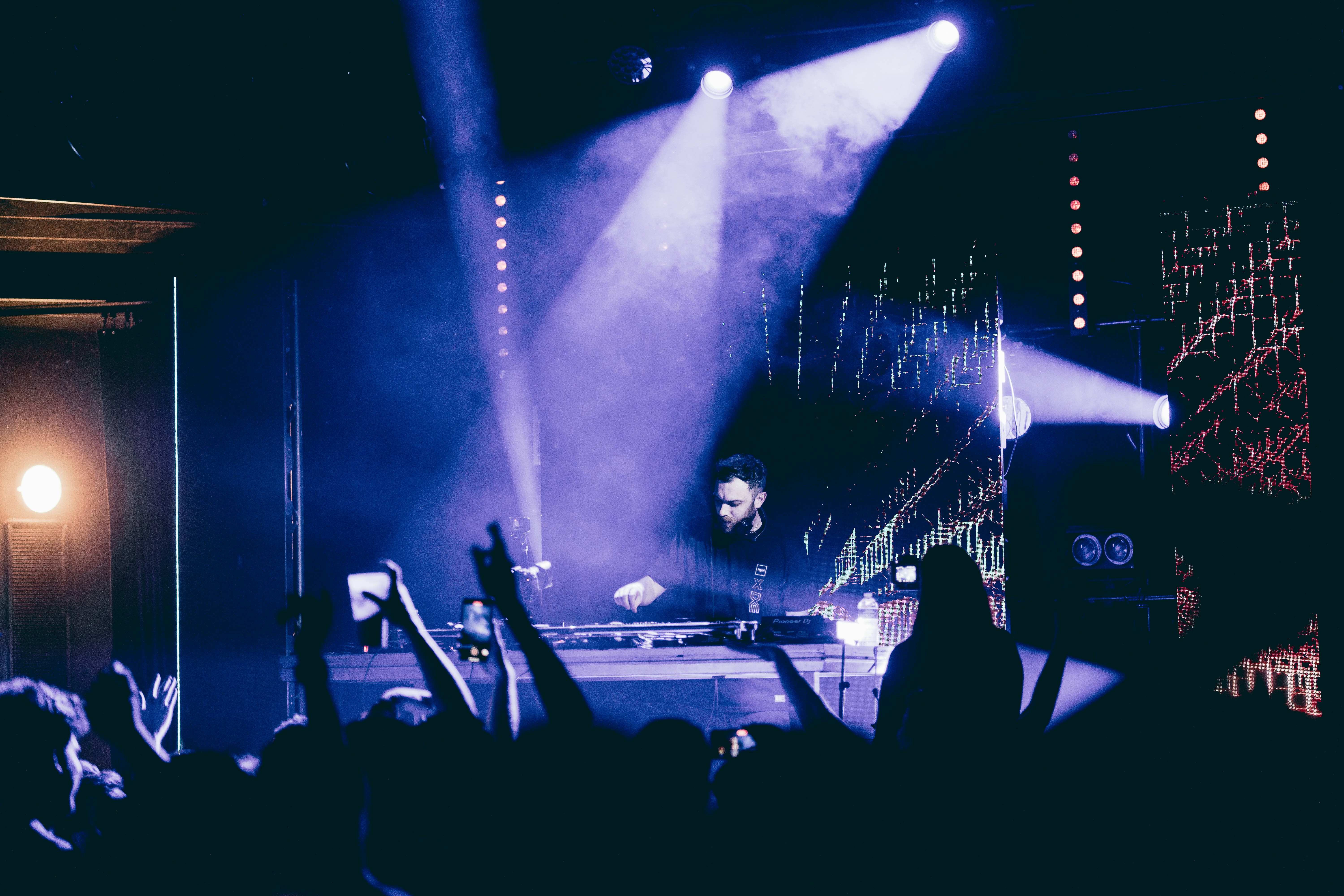 a man standing on a stage in front of a crowd