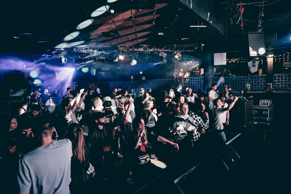 a crowd of people standing around a stage