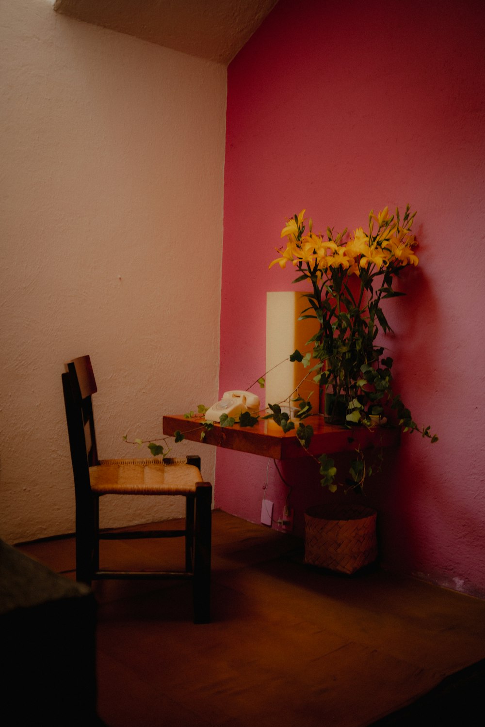 a chair and a table with a vase of flowers on it