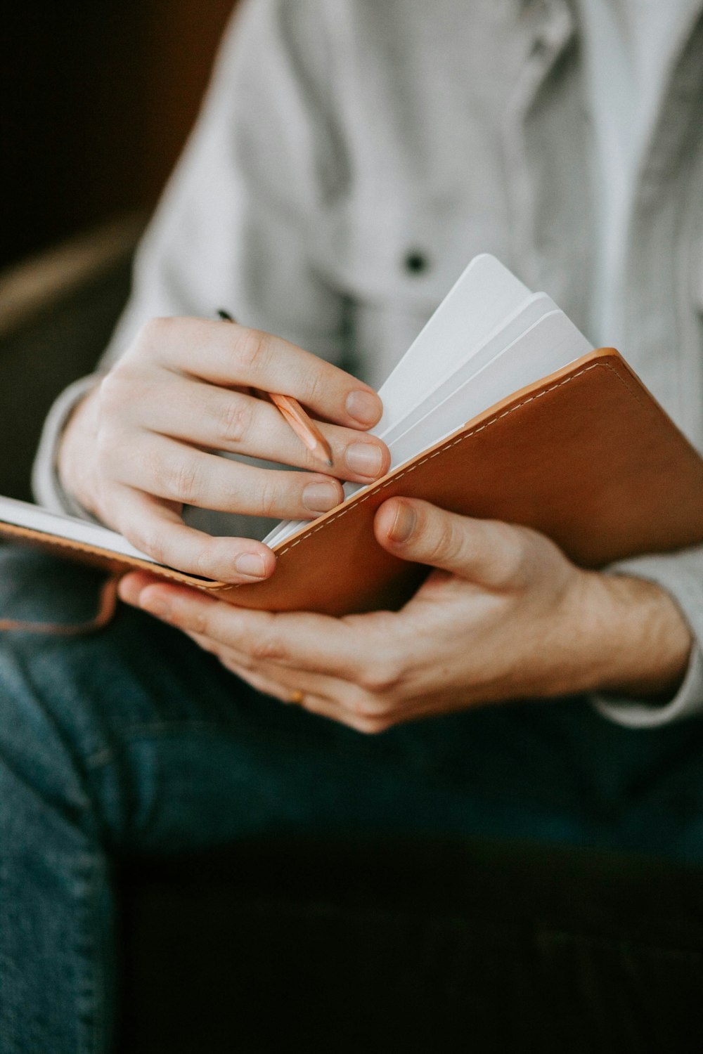 a person sitting on a chair holding a book