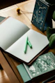 a notebook with a green pen on top of it