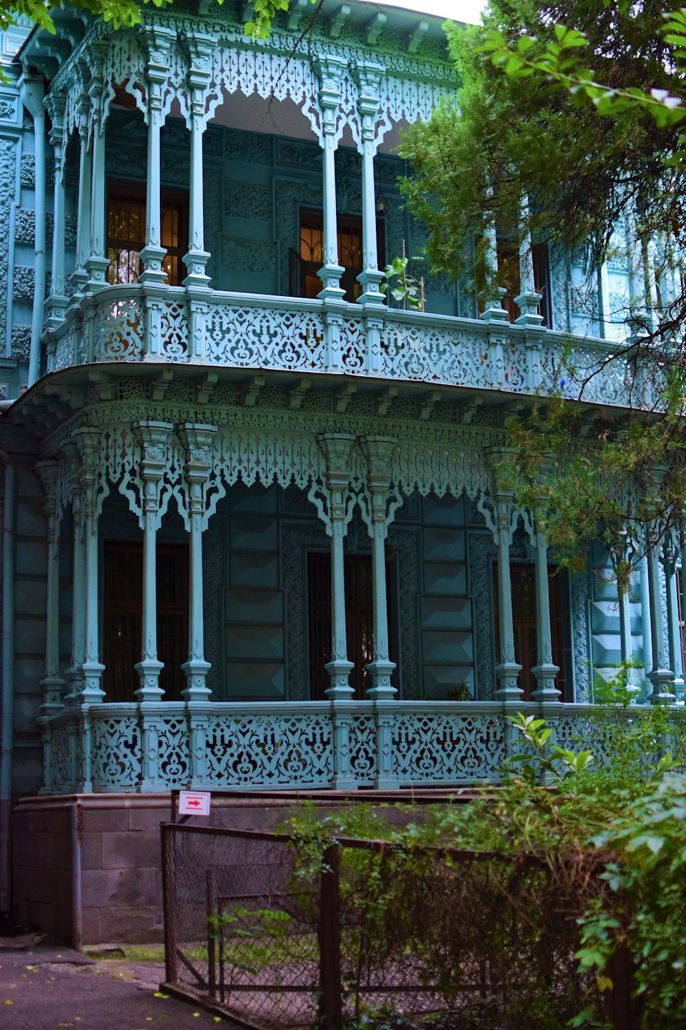 a large blue building with a balcony and balconies