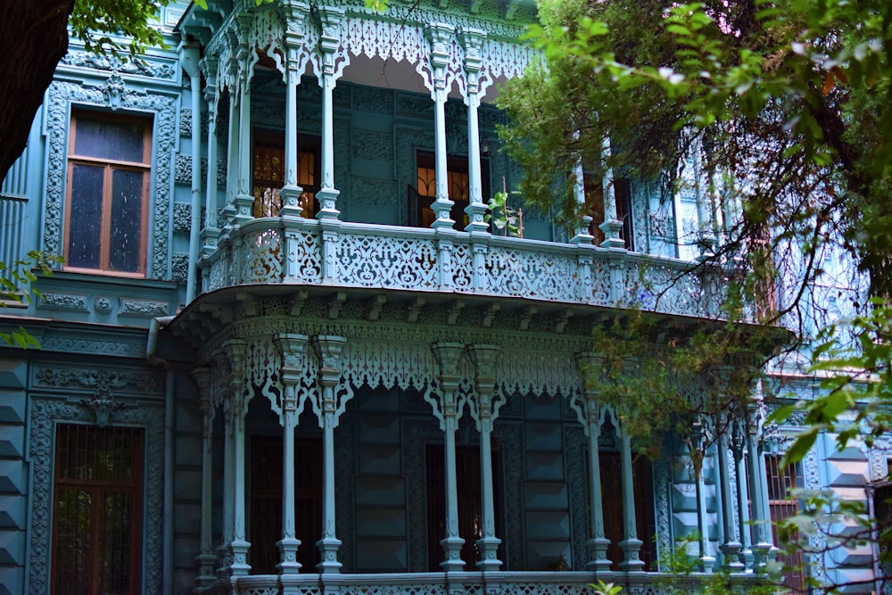 a large blue building with a balcony and balconies