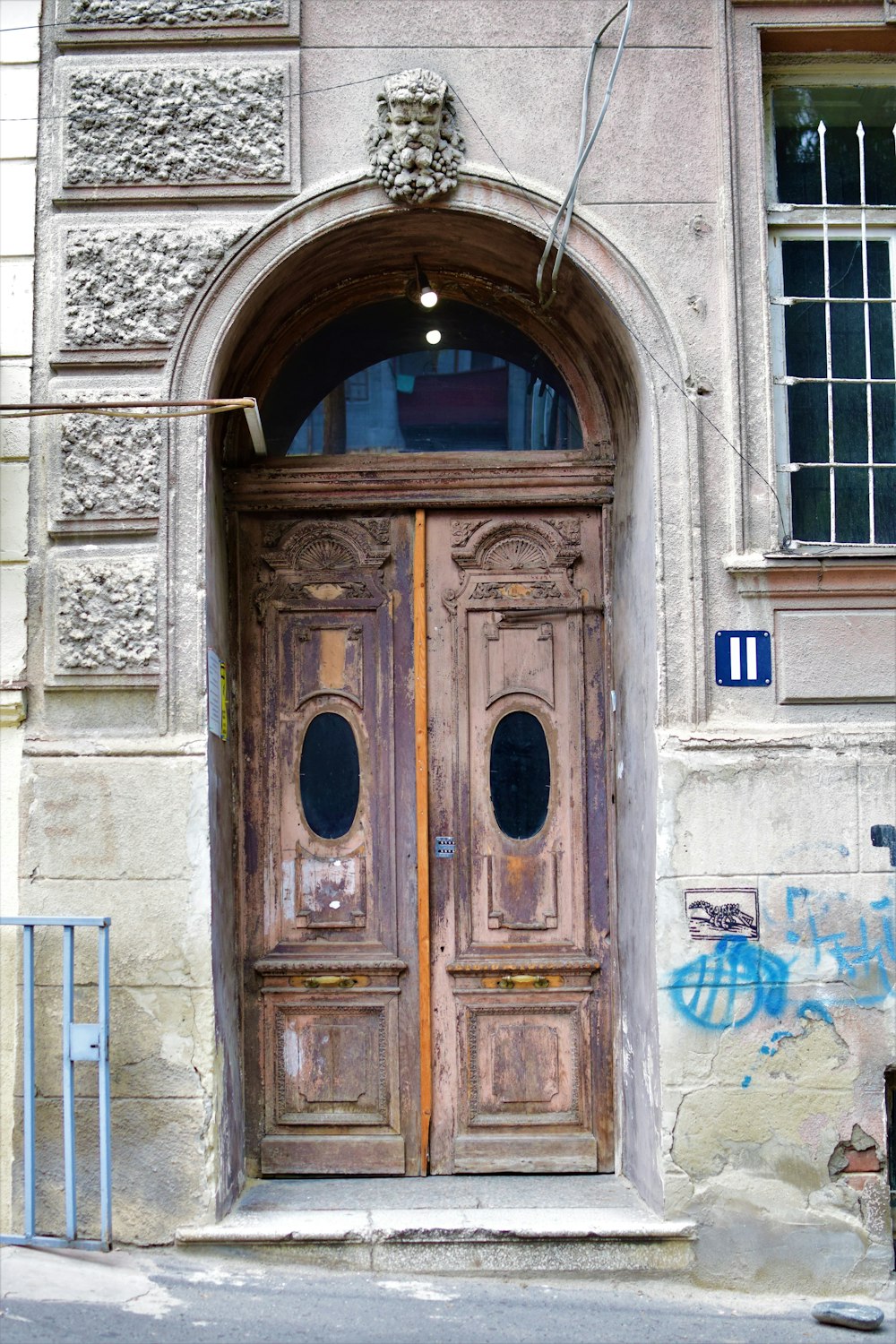 a large wooden door on the side of a building