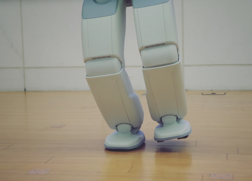 a robot standing on top of a hard wood floor