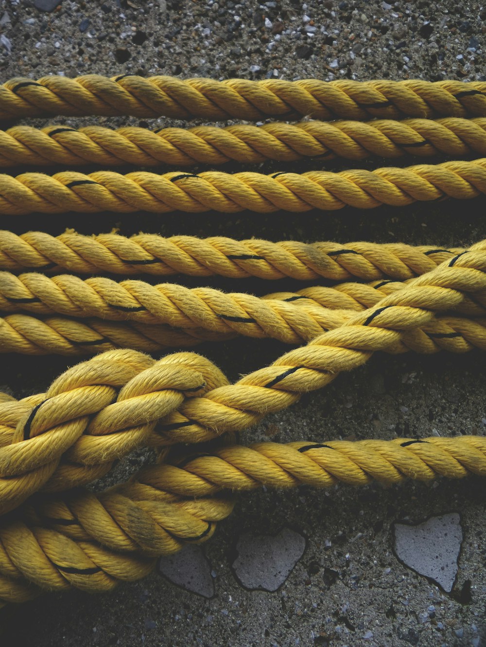 a close up of a yellow rope on the ground