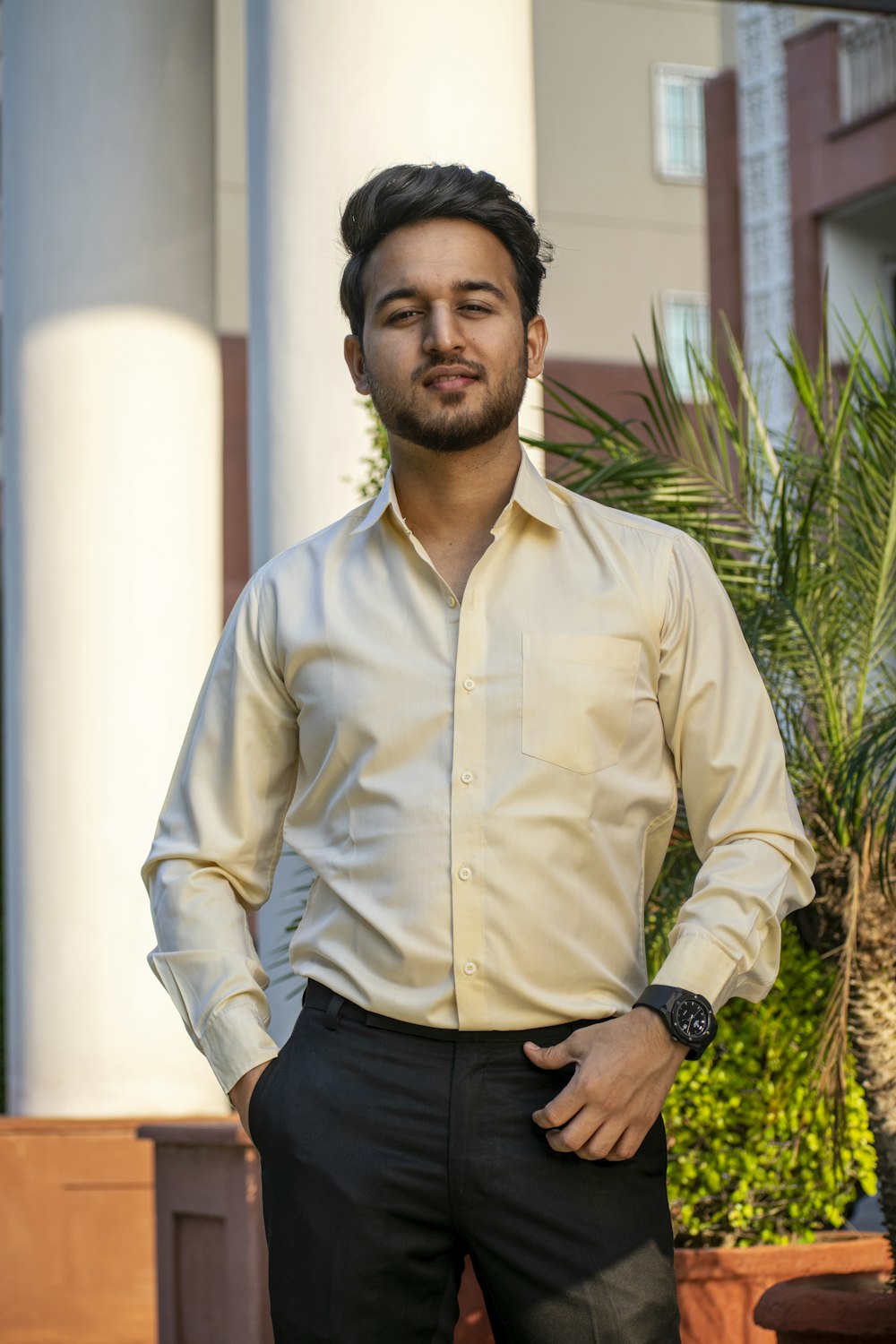 a man standing in front of a tall building