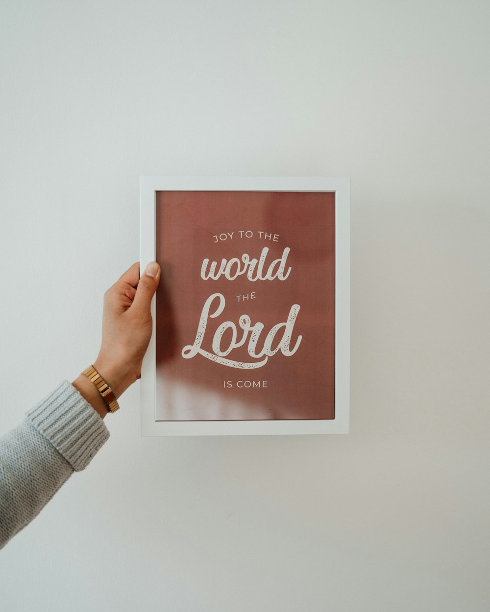 a person holding up a picture with the words, joy to the world the lord