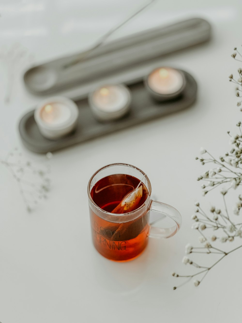 a cup of tea with a spoon next to it