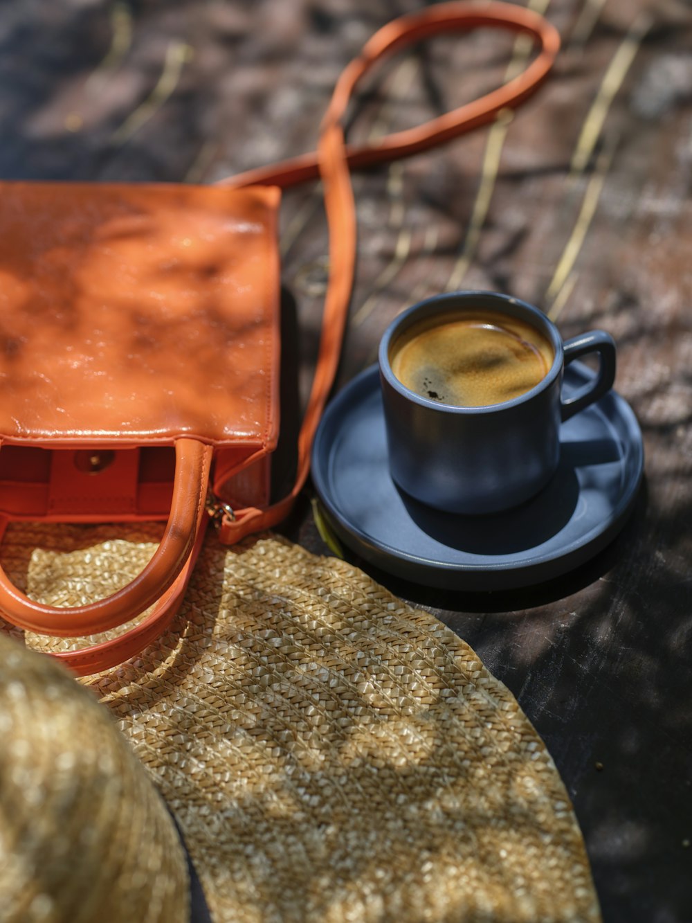 a cup of coffee and a purse on a table
