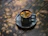 Handcrafted ceramic cup resting on a wooden table with morning light.