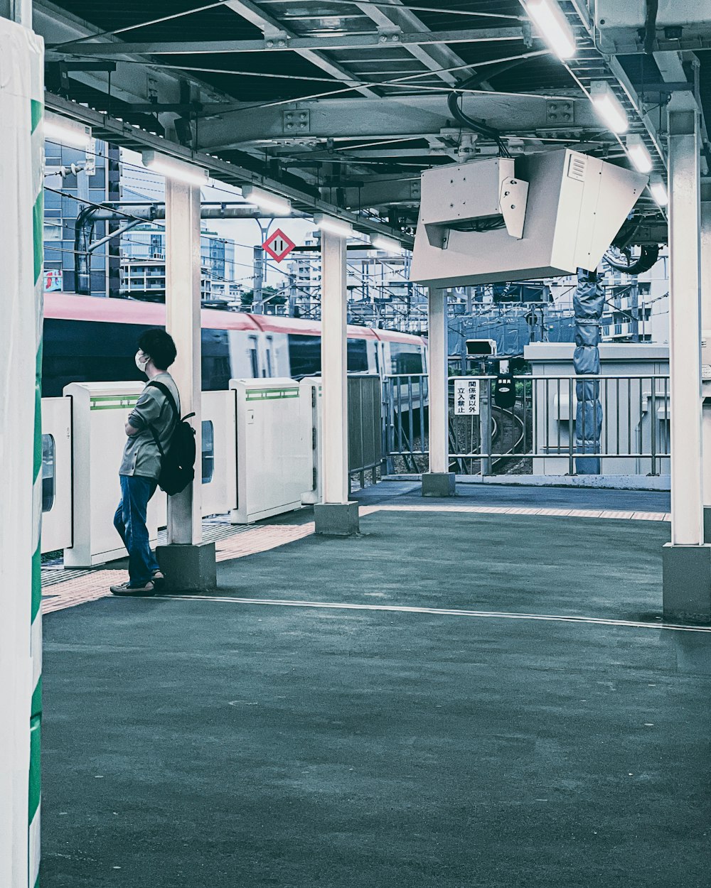 a man standing next to a train at a train station