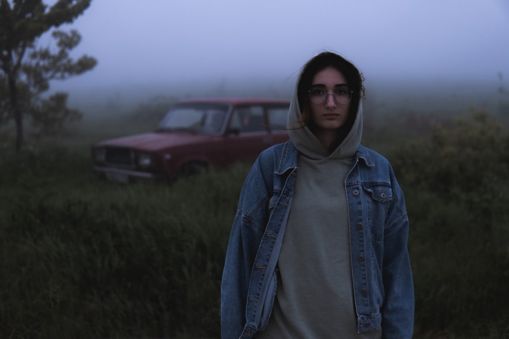 a person wearing a hoodie standing in a field