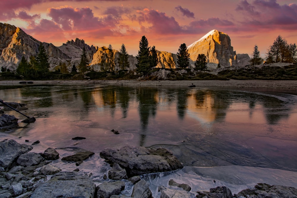 a mountain range with a lake in the foreground