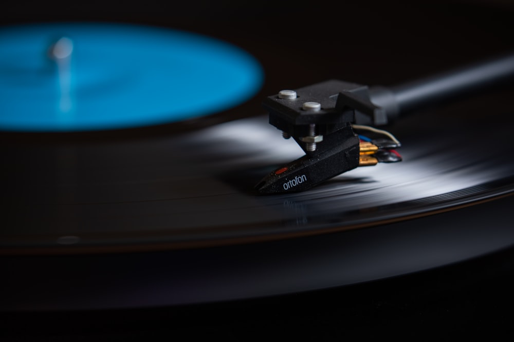 a record player with a blue disc in the background