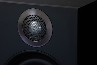 a close up of a speaker on a black surface