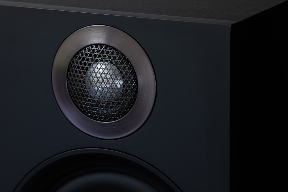 a close up of a speaker on a black surface